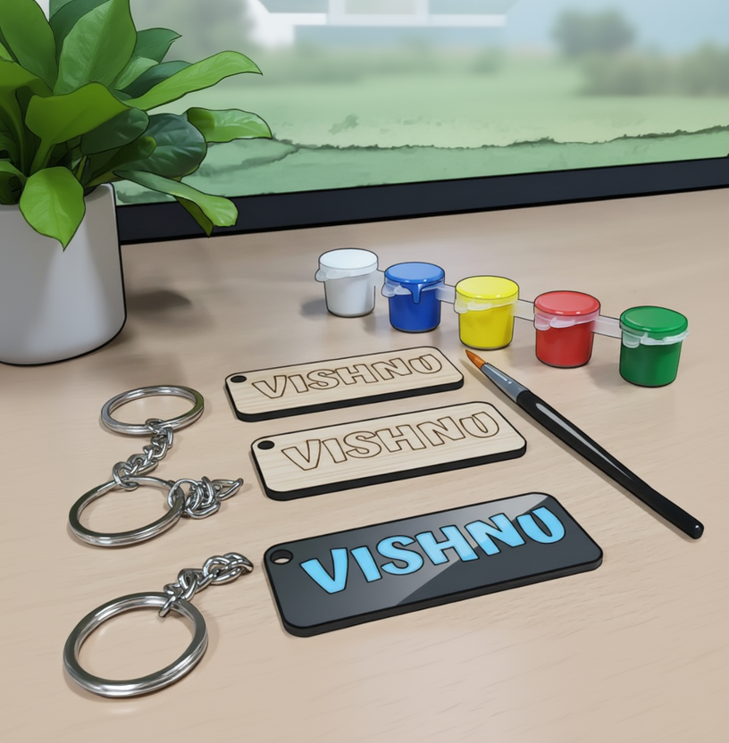 Personalized keychains with 'VISHNU' on a wooden surface with paint containers and a brush.