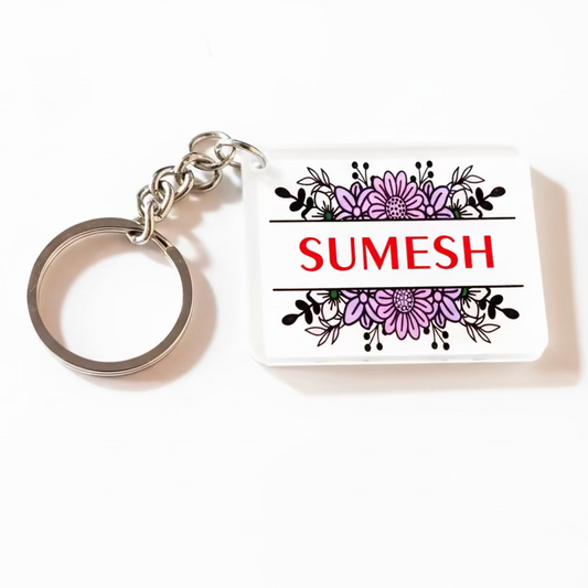 Keychain with floral design and 'SUMESH' text on a white background